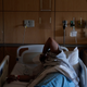 A covid-19 patient lies in a bed at Providence Holy Cross Medical Center in the Mission Hills section of Los Angeles on Dec. 22, 2020.